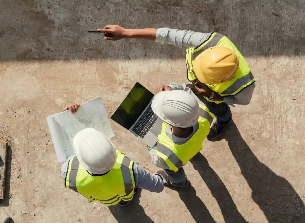 Personas con traje de construcción observando la obra